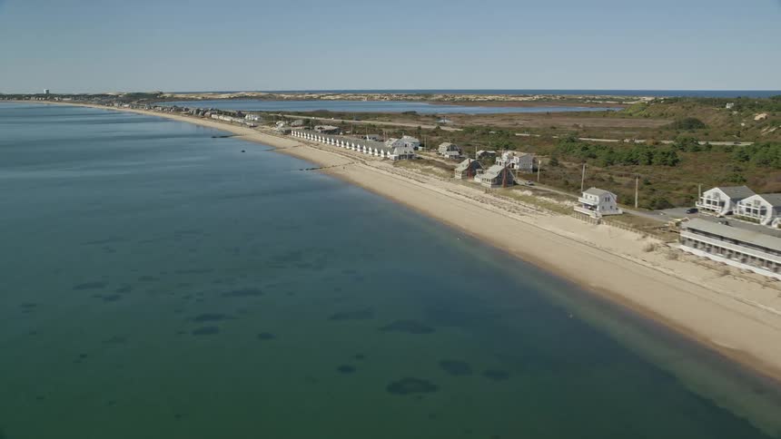 A huge beach with several houses and residences on the shores