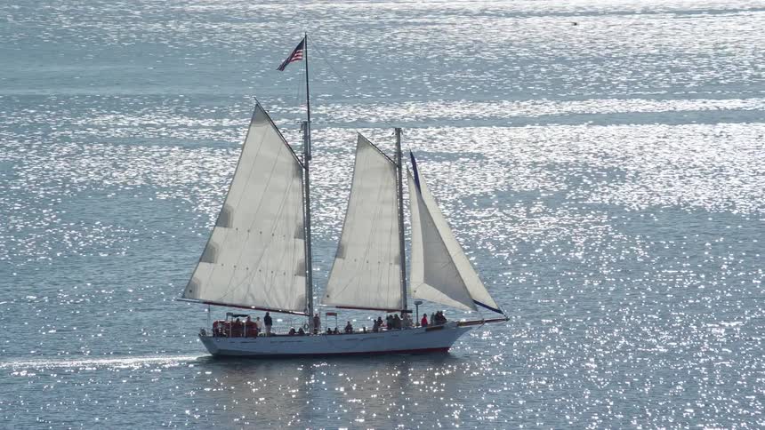 Aerial view of a sailboat carrying passengers at sea