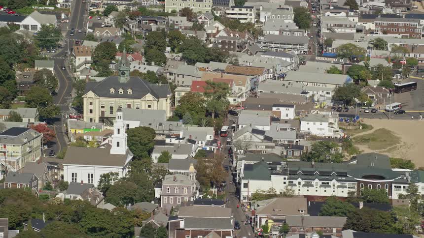 A city with a church that is close to the sands of a beach