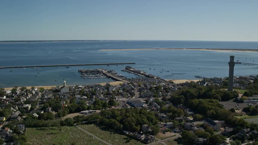 Aerial view of a tower in a small coastal town next to the ocean