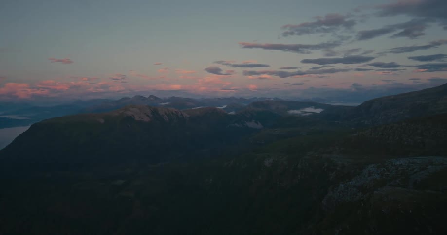 Aerial view of mountains by the sea on a summer evening