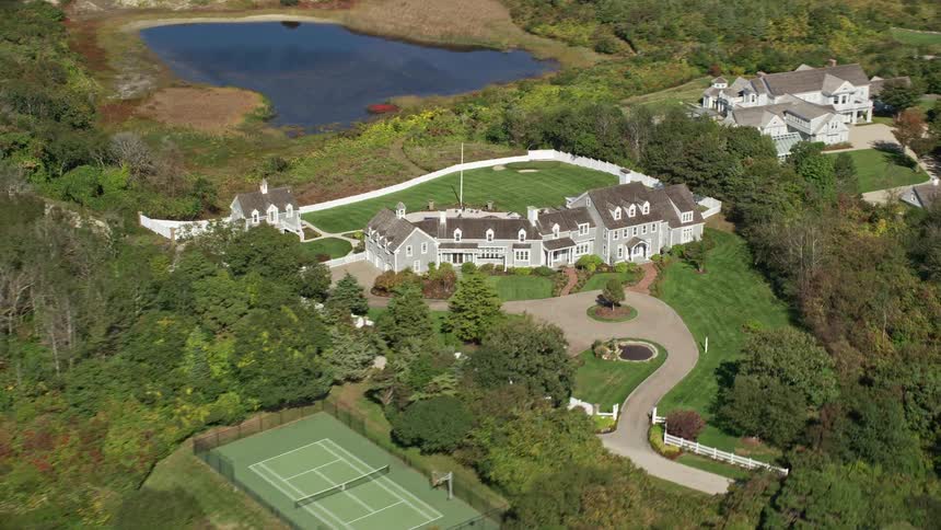 A mansion has a swimming pool and tennis court