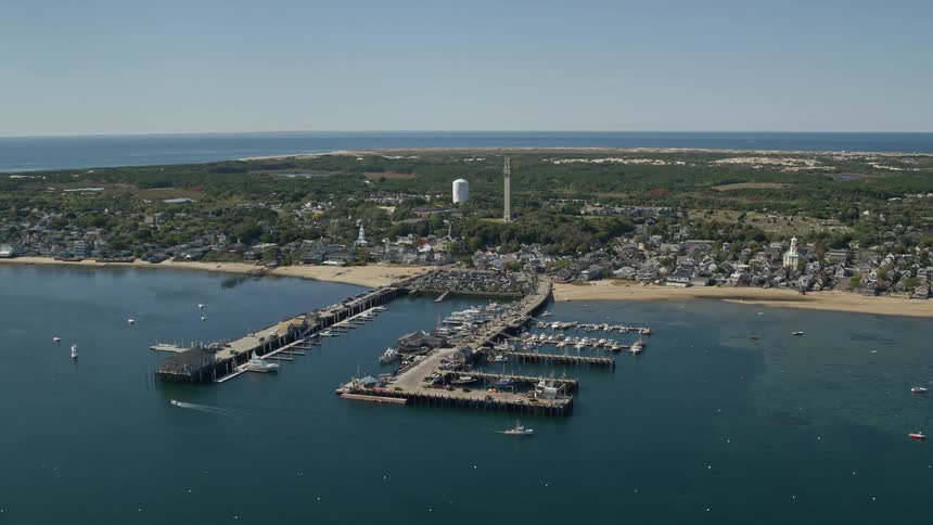 Aerial view of a coastal town on a peninsula a beach and a small harbor