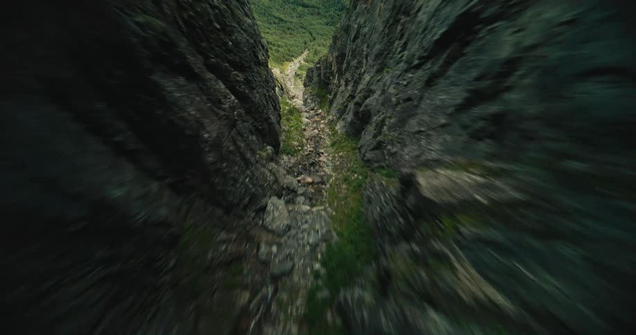 A valley of rocks in a mountain that goes from the top to the base of it