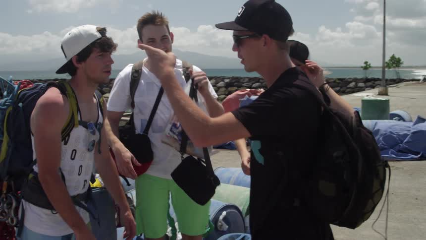 Group of men and women talk on a pier