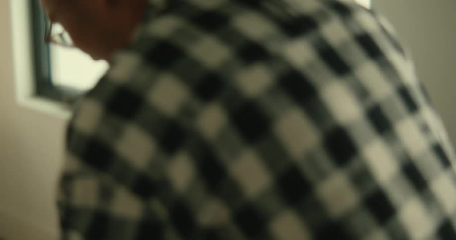 A man kissing his pregnant wife in an indoor setting