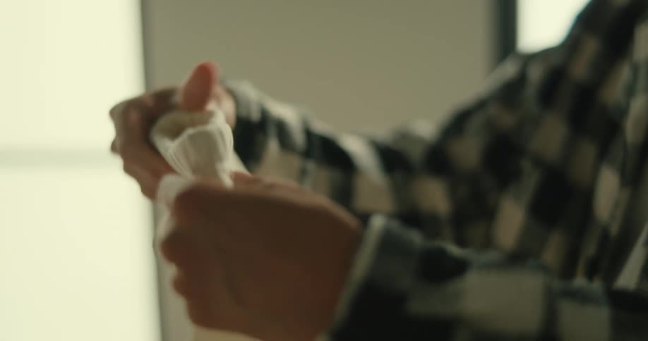 Hands holding a piece of baby clothing