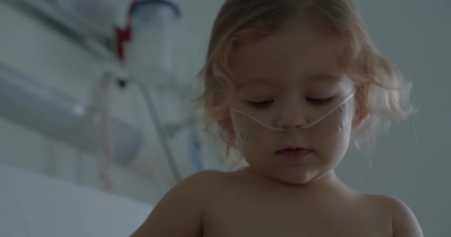 Girl with oxygen feed plays in hospital