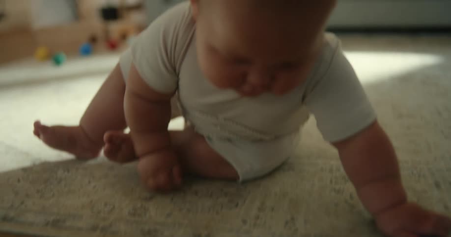 A baby is crawling on the floor