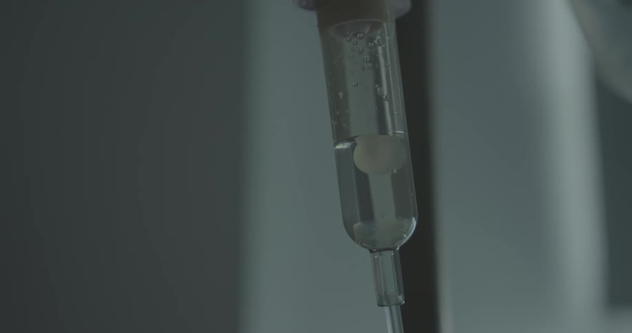 Clear fluid moves in the macrodrip tubing of an iv drip chamber