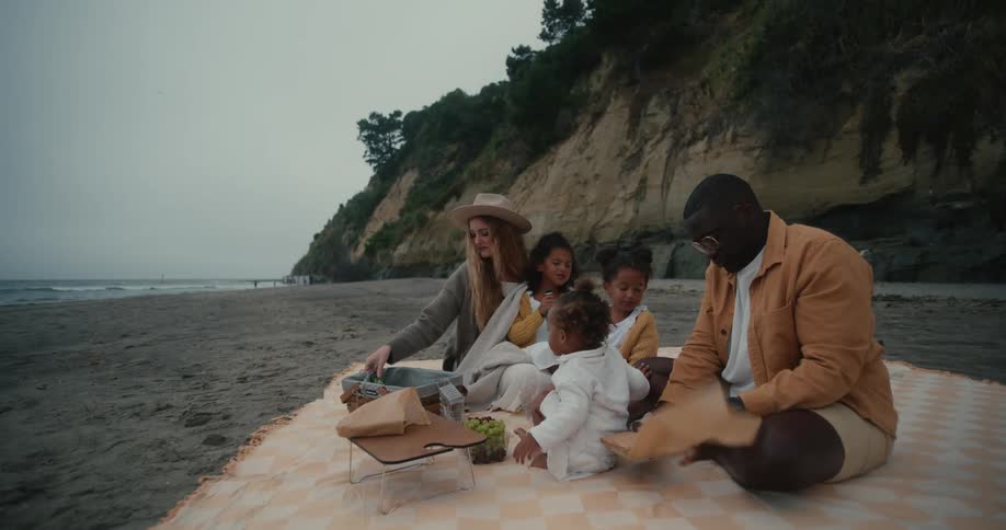 A family having a picnic on the beach on a cloudy day