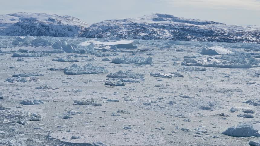 A region in the arctic with a sea full of ice and snow on the surface
