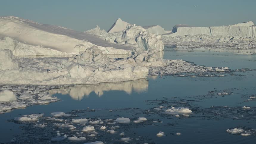 A large iceberg floating on top of a body of water