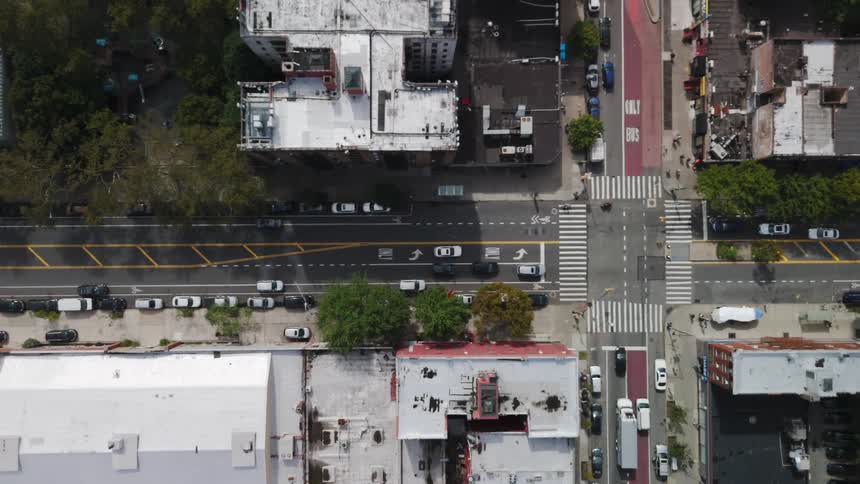 A street with an intersection in a region with many buildings