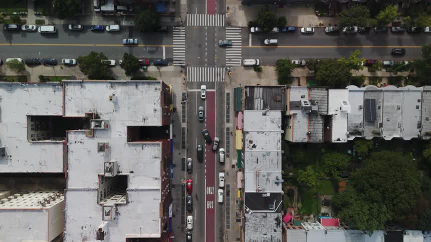 Traffic drives by the intersection in the city