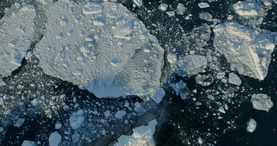 Aerial of an iceberg floating in the arctic sea