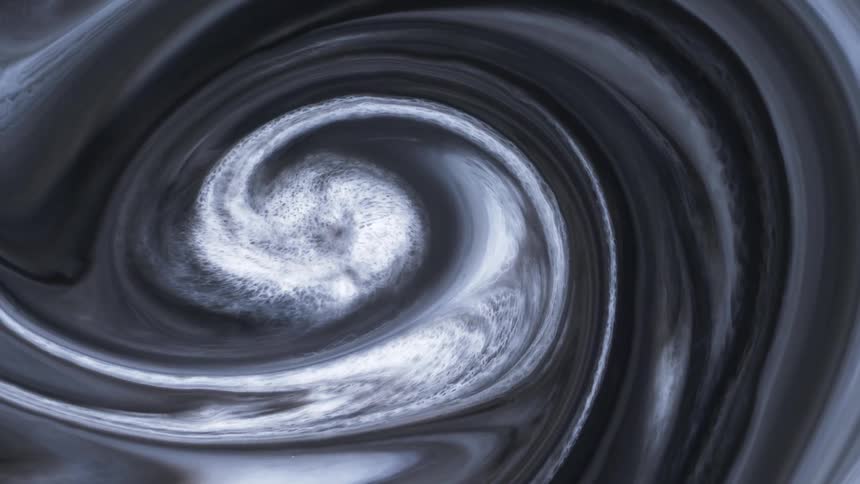 Black white and gray layers spiral toward bright cloudy center