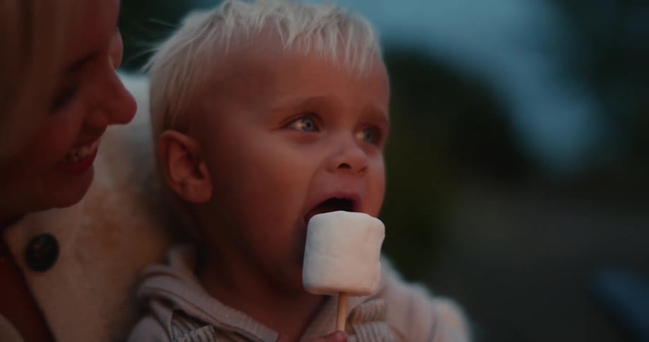 A child is eating a marshmallow