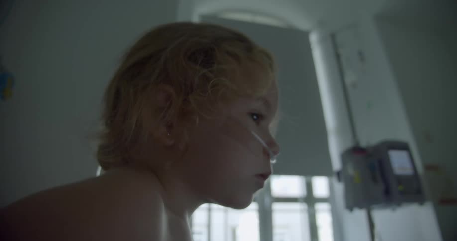 A child with an oxygen cannula in his nose in the hospital