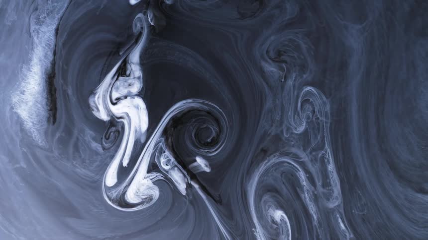 Whisps of swirling white ink spinning