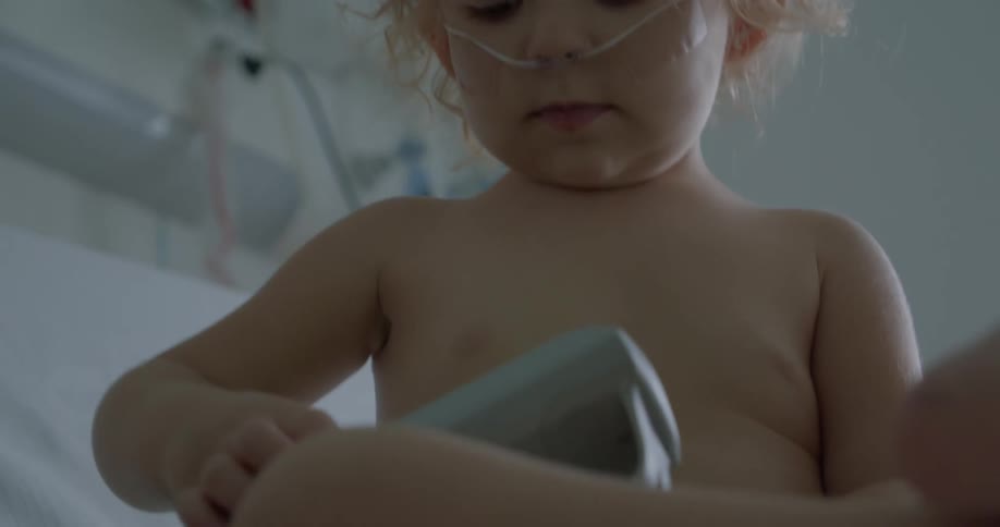 A child with oxygen in his nose in a hospital