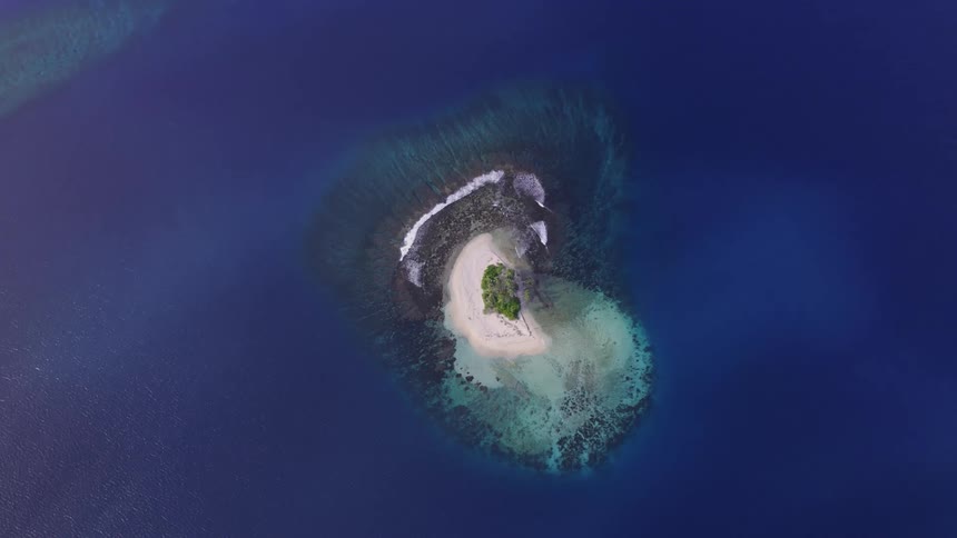 Top down aerial view of a small island in the ocean