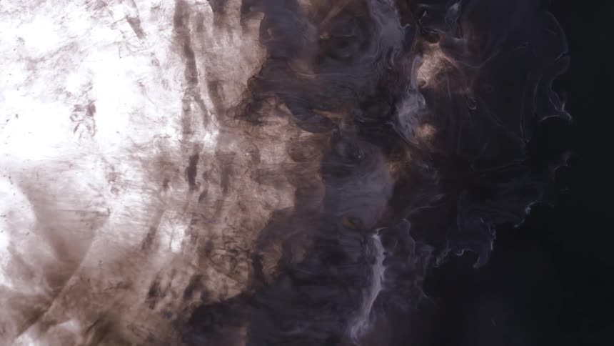 Deep in space a bright light on the left as the cloud slowly moves to the right into a dark area