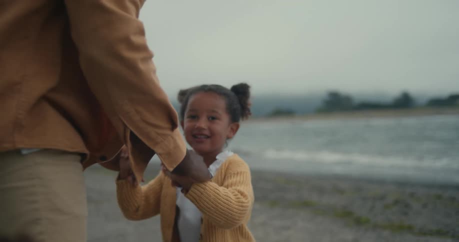 A father playing with his daughter on the beach