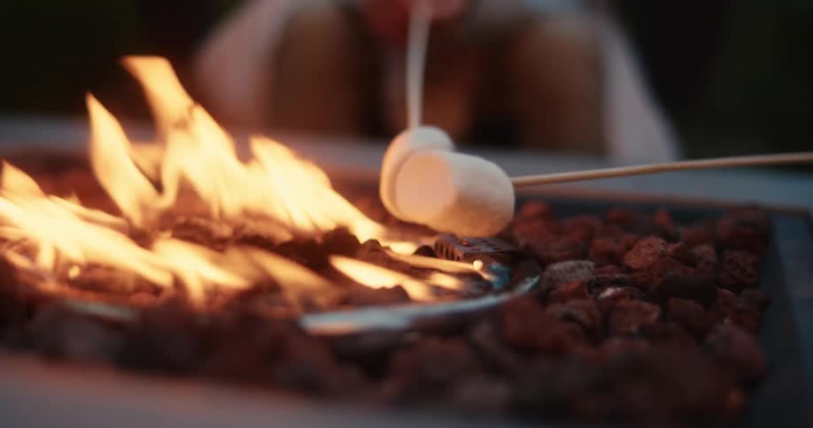 People sitting around a made fire in the evening