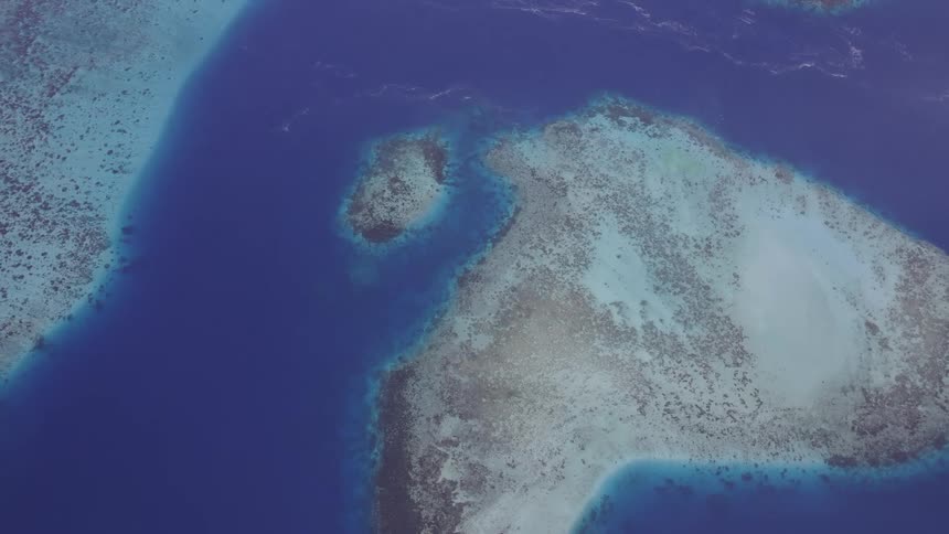Aerial of the islet in the blue ocean