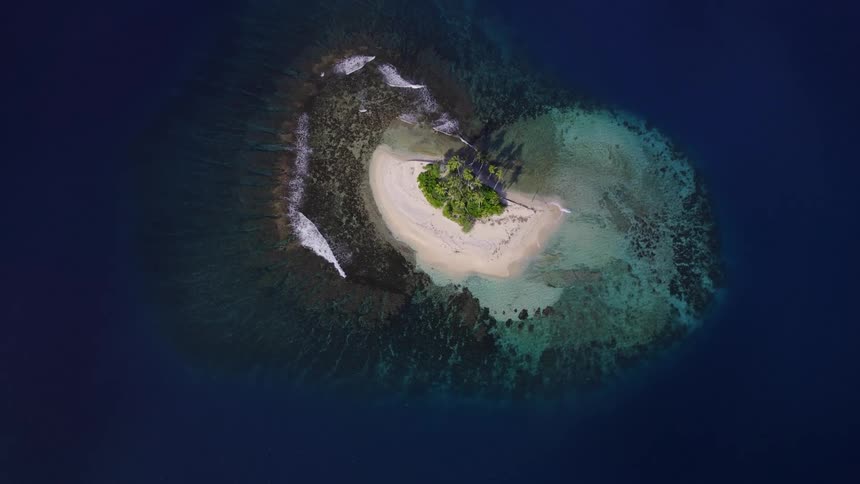 Tropical island with white sand beaches and palm trees surrounded by crystalclear water