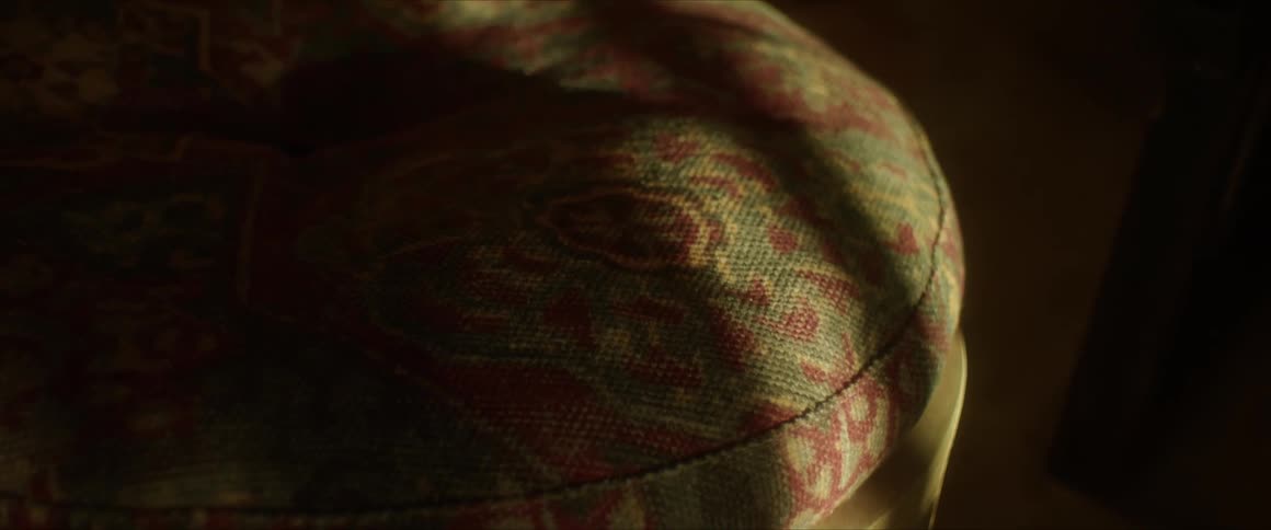 A closeup of a round cushion on a chair