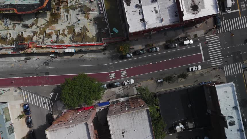 Aerial view of a city with streets and cars passing