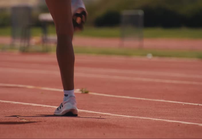A runner is stretching on the track
