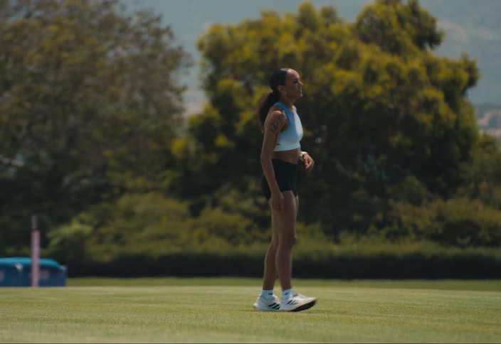 A woman exercising outdoors in a field