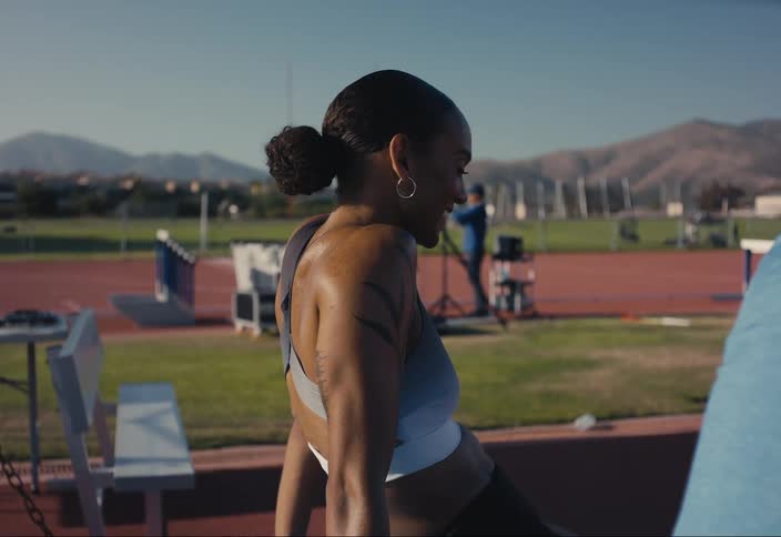 A woman talks to her coach after a race