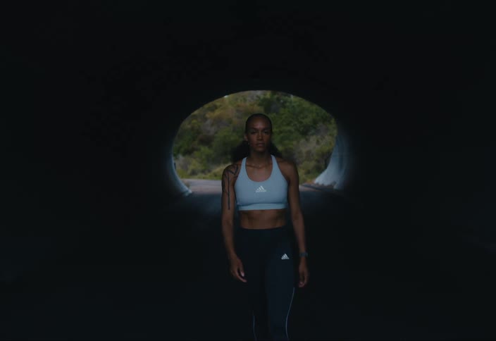 Woman walks out of a tunnel