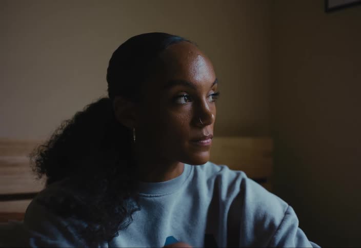A woman looks out a window