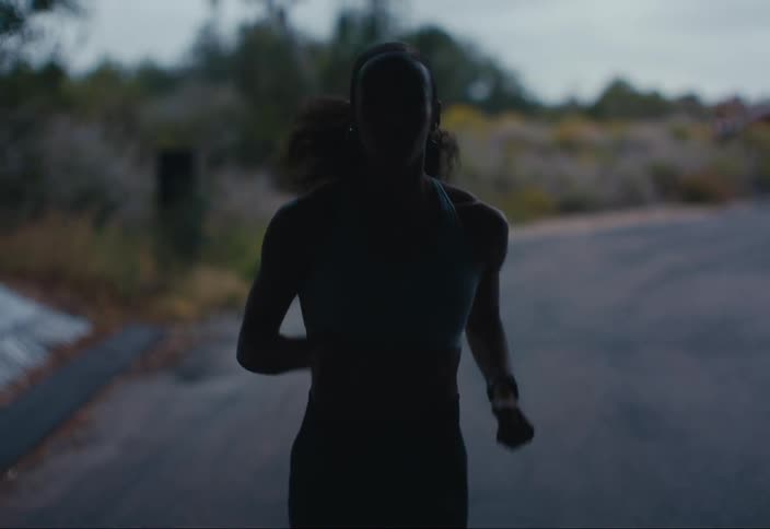 A woman runs through a tunnel