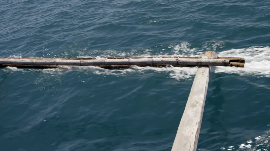 The side of a boat is gliding on top of the water