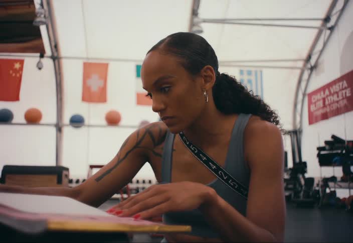 A woman is writing notes in a gym