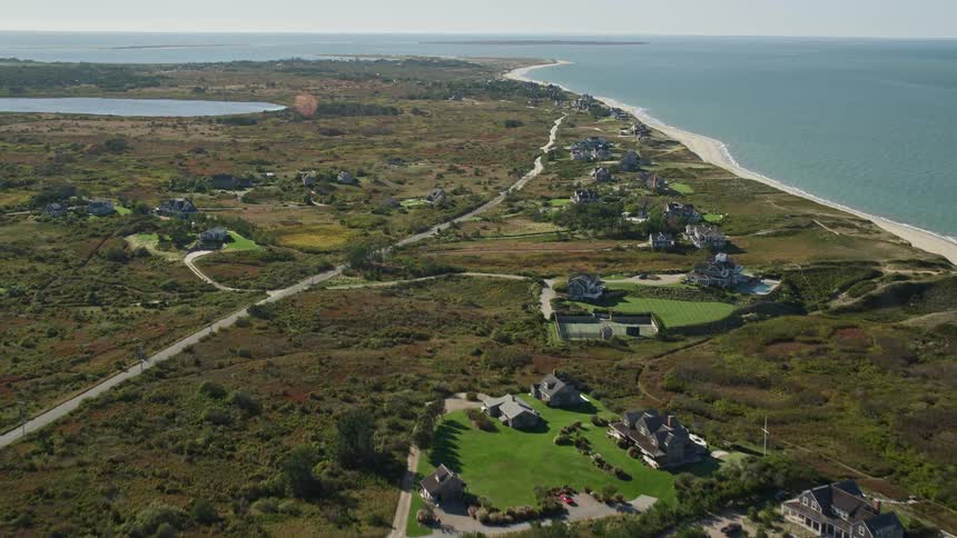 Aerial view of beachfront houses and a highway along the beach