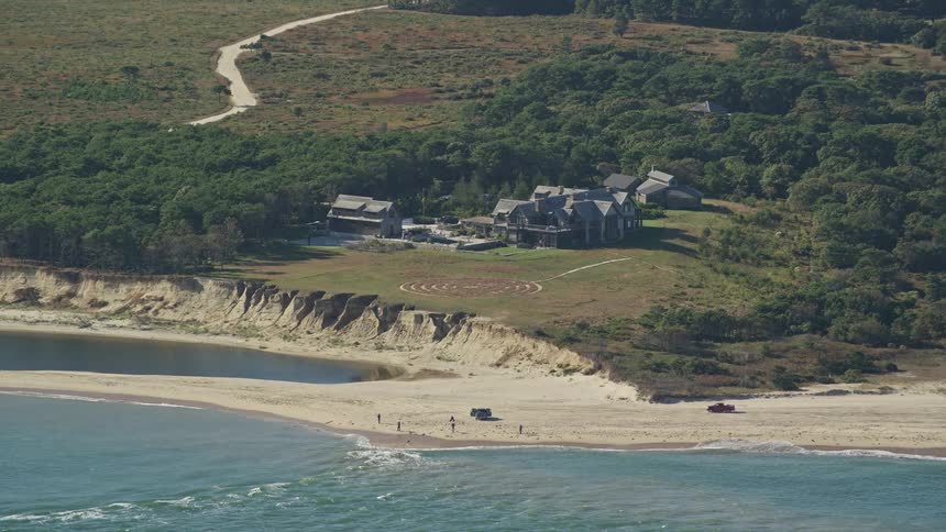Aerial panorama of a beach with a small group of people on the sand