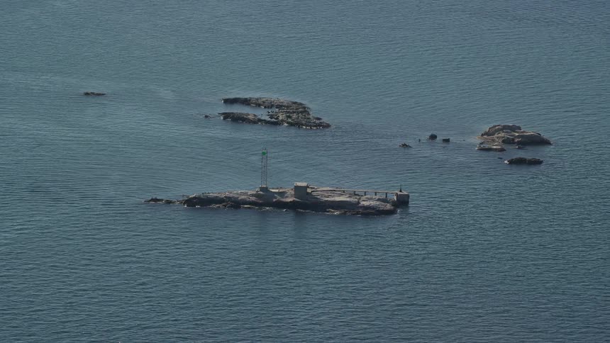 Aerial panorama of rocks with a tower in the middle of the sea