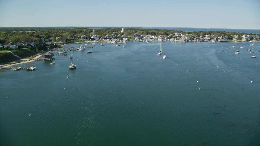 Aerial view of boats on a marina next to a small town