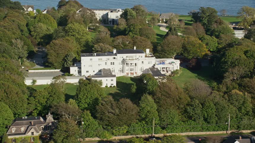Aerial panorama of mansions amidst green areas by the seaside
