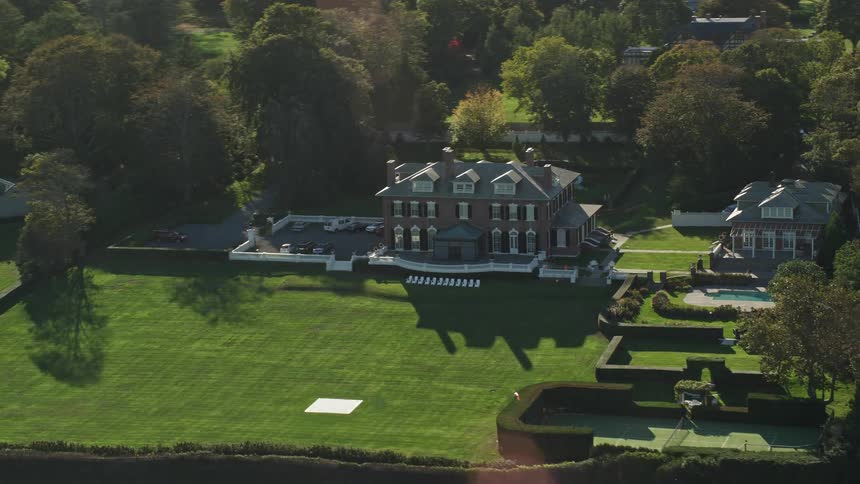 Aerial panorama of a resort with fields and a pool