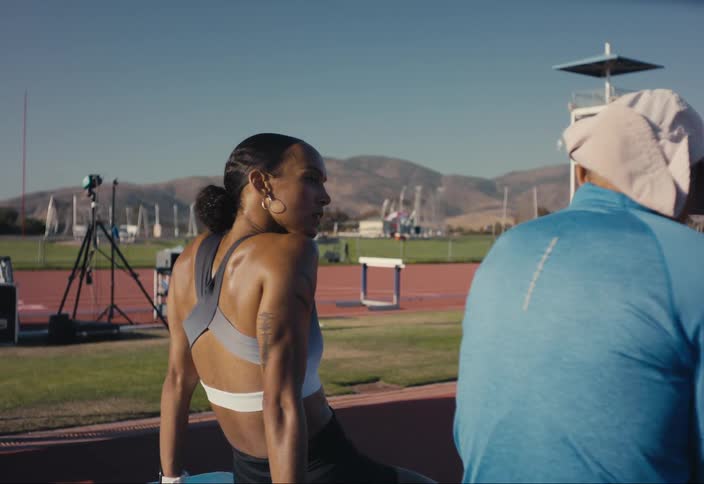 An athlete and coach talk after a race