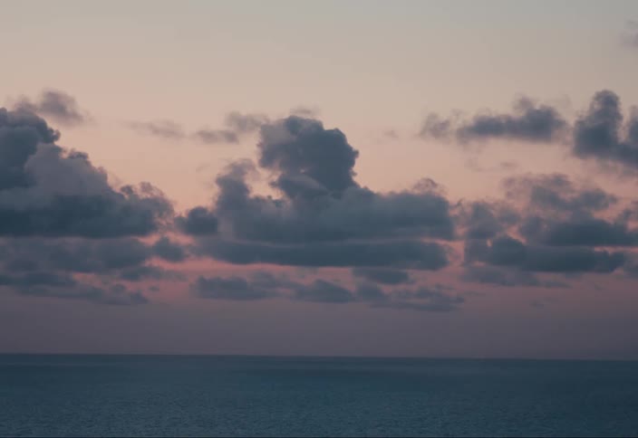 The sun is setting on the ocean