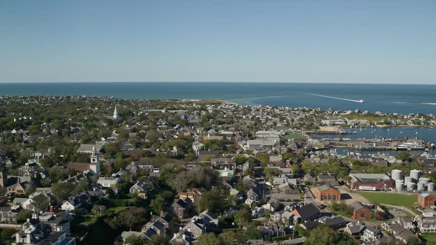 Aerial panorama of a residential city by the sea with docks for boats and yachts